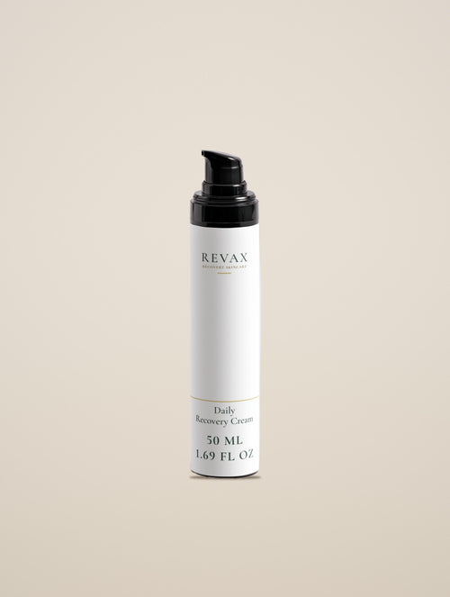 REVAX Daily Recovery Cream 50 ml bottle with black pump on a warm cream background, front view